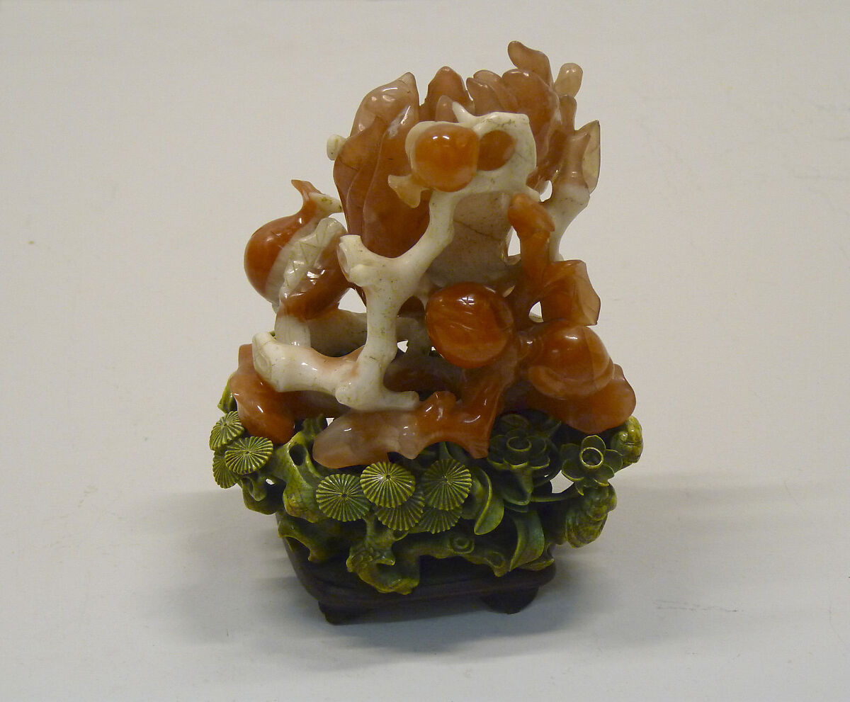Eighteenth-century carnelian and agate carving combining finger citrons, peaches, pomegranates, and fungus leaves